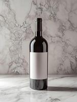A bottle of wine sitting on a marble counter photo