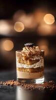 A dessert in a glass with chocolate and cream photo