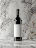 A bottle of wine is sitting on a marble counter photo