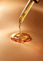 Pipette with a drop of essential oil on a brown background. Golden Serum Dropper photo