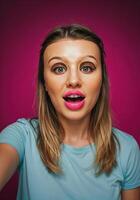 Portrait of a beautiful young woman with pink lips on a pink background. Surprised Woman Selfie photo