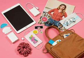 Flat lay of modern woman with mobile phone and accessories on pink background. Girls Tech and Fashion Accessories photo