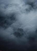 a dark and stormy sky with clouds and fog. Misty Mountain Peak photo