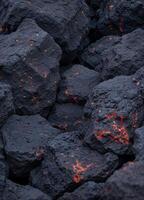 a close up of coal with red and orange flames. Glowing Volcanic Rocks photo