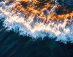 Aerial view of the sea waves at sunset. Natural background. Golden Ocean Waves photo