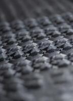 Close up of carbon fiber composite material, industrial background, selective focus. Carbon Fiber Weave Texture photo