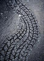 Tire tracks on asphalt road. Background and texture for design. Tire Tracks on Asphalt photo