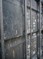 close up of old cargo container for transportation of goods, industrial background. Spiderweb scratch on Cargo Container photo