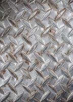Old metal sheet with rhombus pattern, background and texture. Rusty Diamond Plate Metal photo