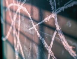Close up of a scrapped chalk lines residue on a chalkboard. Shallow depth of field. Chalk Marks on Brick photo