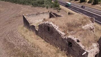 Drone over ancient building ruins in the middle of a farmer's field on a cloudy day video