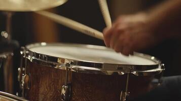 A close up of a drummer playing a drum photo