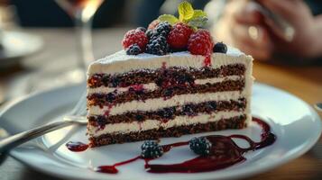 A slice of cake with berries and whipped cream on top photo