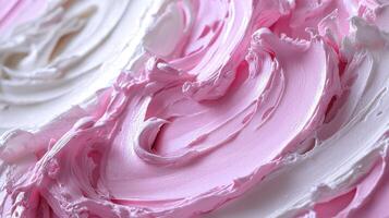 A close up of a white frosting with pink swirls photo