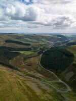 Winding road leading through green hills in wales photo
