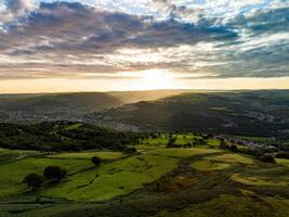 Sunset casting shadows over the green hills of wales photo