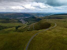 Winding road leading through green meadows in the welsh countryside photo