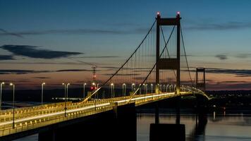 The severn bridge connecting england and wales at sunset photo