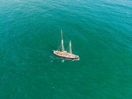 Classic sailing yacht navigating the turquoise waters of newquay photo