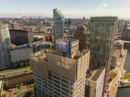 Liverpool Construction site with crane towering over liverpool's skyline on sunny day photo
