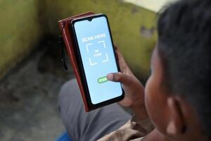 Person Using Smartphone App to Scan QR Code for Digital Payment photo