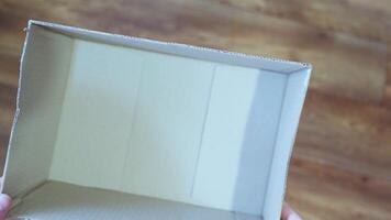 An empty cardboard box held in hands, ready for use video