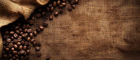 Top View of Dark Roasted Beans on Rough Woven Burlap with Warm Lighting photo
