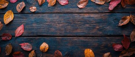 Rustic Wooden Surface with Scattered Autumn Leaves photo