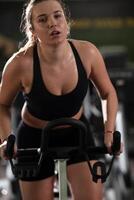 A focused fitness woman performing a conditioning workout in the gym, pushing her limits with strength, determination, and intense dedication. photo
