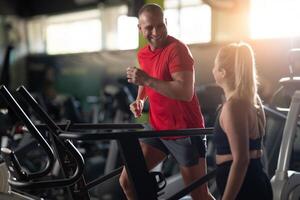 A couple working together in the gym, performing a conditioning workout side by side, supporting each other with strength, motivation, and teamwork. photo