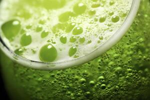 A glass of green liquid with bubbles photo