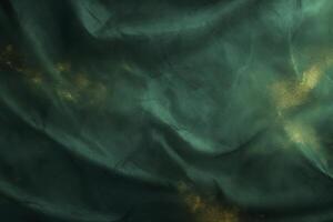 A green fabric with gold glitter on it photo