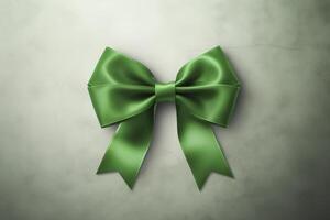 A green ribbon bow is on a white background photo