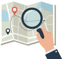 A hand holding a magnifying glass over a map in a flat design art vector