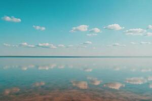 Serene reflection over calm waters under bright blue sky photo