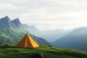 Bright orange tent stands on green grass with mountains in background photo