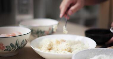 Handheld selective focus shot, Young woman's hands is preparing the process of coating chicken with all the ingredients in a bowl before frying the chicken on a pan. Cooking concept, Food preparation video