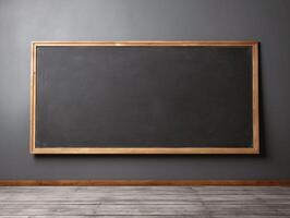 A large blackboard sits against a gray wall. The board is empty, with no writing on it. The room is bare and empty, with no furniture or decorations photo