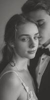 Young caucasian couple in formal attire sharing an intimate moment, with elegant and timeless expressions photo