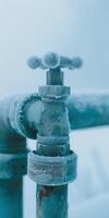 Frozen Metal Pipe with Frost in Cold Winter Weather Displaying Freeze Impact on Plumbing System photo