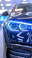 Sleek blue luxury car with led headlights in a modern showroom setting photo