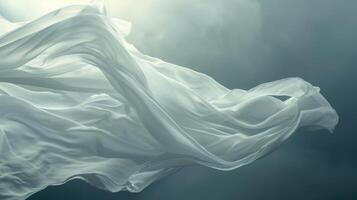 Flowing white fabric against a dramatic cloudy sky photo