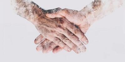 Close up of two adult hands in a handshake gesture with textured overlay photo