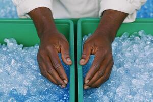 Hands Sorting Ice Cubes in Green Containers Refreshment and Cooling Concept photo