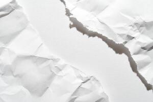 Close-up of torn white paper with rough edges and textured surface creating abstract composition. photo