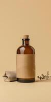 Amber glass bottle on beige background with cork top and brown label in minimalist setting photo