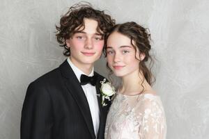 Teen caucasian young adults in formal attire smiling at a special event photo