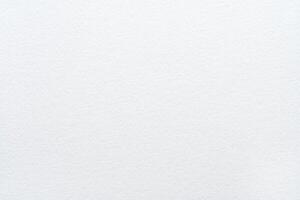 Close-up of blank textured white paper surface with subtle patterns and soft lighting. photo