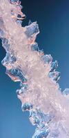 Close up of clear ice structure against a deep blue sky in natural light photo