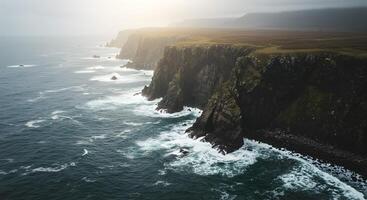 Aerial View of Jagged Cliffs and Ocean Waves Illuminated by Golden Hour Light photo
